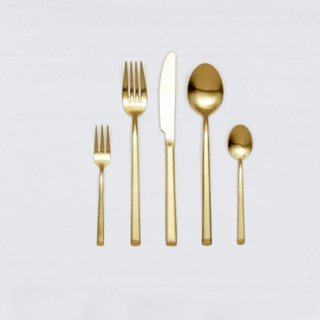 Cutlery Set Ines Gold Matte 5-pieces | With the cutlery series Ines we rent out wonderful, matt-gold stainless steel cutlery. The cutlery has a wonderful haptic and looks equally good for different types of events. Whether on a colourful table setting combined with strong colours, an elegant, minimalistic wedding or a stylish business dinner - our matt gold cutlery Ines is an excellent choice for your event.The assembled set of rental cutlery contains a dinner fork, a dinner knife, a table spoon, a cake fork and a teaspoon.Impress your guests, rent the 5 piece matt-golden cutlery sets Ines and combine it with our vintage tableware.Matching the matt gold cutlery set Ines, we also offer teaspoons, cake shovels, serving spoons, butter shovels and vintage stemware for rent. | gotvintage Rental & Event Design