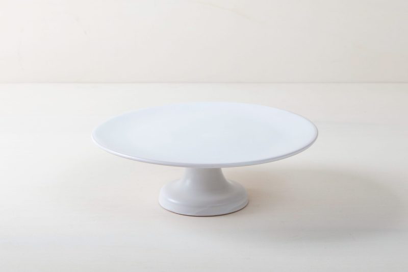  | Our medium size elevated cake stand Ernesta rests on a 13 cm high foot and has a diameter of 35 cm. Enough space to present and serve cakes, cupcakes, sushi and other delicious food on the table or at the modern buffet. The serving trays are handcrafted from high-quality terracotta and glazed matt white, of course food safe.These cake stands are available in three different sizes as well as a matt black serving plate. They can be wonderfully combined for presentations. | 