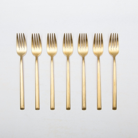 Starter Fork Ines Cutlery Gold Matt | With the cutlery series Ines we rent out wonderful, matt-gold stainless steel cutlery. The cutlery has a wonderful haptic and looks equally good for different types of events. Whether on a colourful table setting combined with strong colours, an elegant, minimalistic wedding or a stylish business dinner - our matt gold cutlery Ines is an excellent choice for your event.Hire the starter fork Ines to delight your guests with the special cutlery.Matching the matt gold starter fork Ines, we also offer dinner forks, dinner knives, as well as table spoons, teaspoons and last but not least, cake shovels, serving spoons, butter shovels and vintage tableware for rent. | gotvintage Rental & Event Design