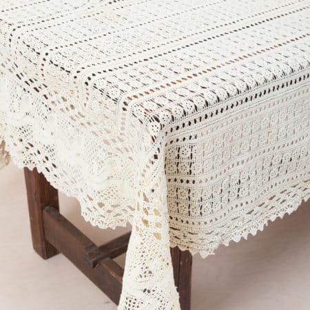 Tablecloth Hosteria Lace | This decorative lace tablecloth is a romantic backdrop for a reception table, a gift table or simply as an eye-catcher on a long dining table. The fine pattern gives the lace a festive boho look. Made from sheer fabric, the tabletop or another tablecloth underneath shows through beautifully.The look is perfect with our candle holders Loretta in brass and romantic vintage tableware Margarita. We also offer the matching tablecloth Iruya. | gotvintage Rental & Event Design